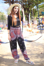 Load image into Gallery viewer, Black Harem Pants with Red Floral Designs and Pocket . Made out of Viscose. Perfect for women in the summer. Bohemian Vibes.
