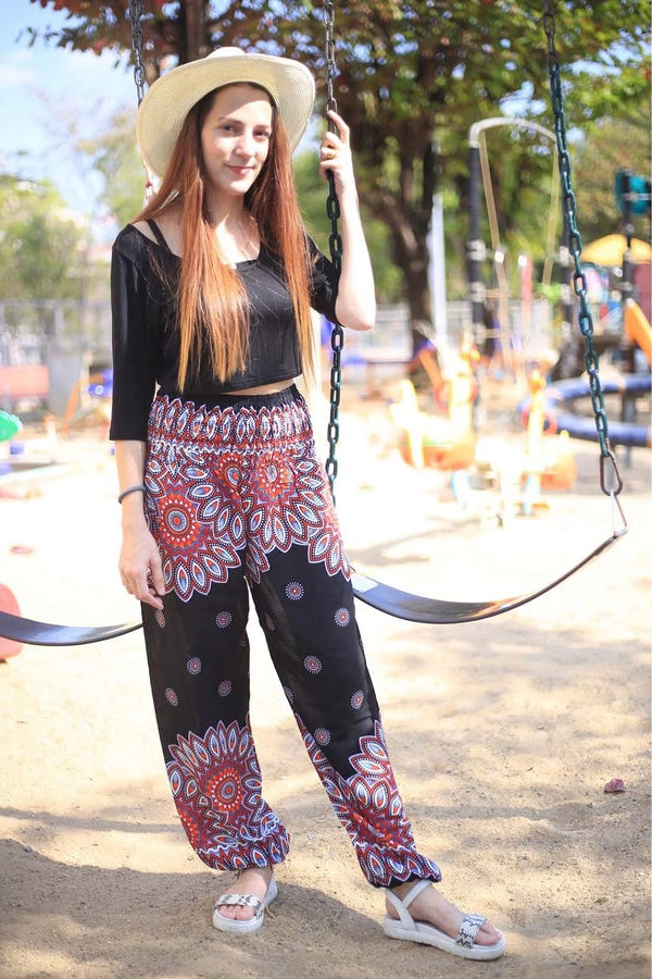 Black Harem Pants with Red Floral Designs and Pocket . Made out of Viscose. Perfect for women in the summer. Bohemian Vibes.