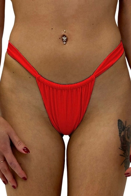 Sexy Addison swimwear. Red thong bikinis that tops and bottoms sold separately. Shimmery red fabric bikini available in store at SunLaced Apparel or online at SunLaced .com. Free shipping anywhere in Canada.