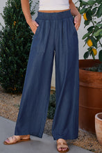 Load image into Gallery viewer, Blue Pants with a Smocked Waist, Pockets, and a Flowing Leg.
