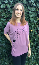 Load image into Gallery viewer, Lilac Off-Shoulder Slouch Bamboo Hand Made Tee With Dandelion Graphic Design.
Bamboo tops in Abbotsford. Bamboo clothing in Abbotsford. Bamboo fashion Abbotsford.
